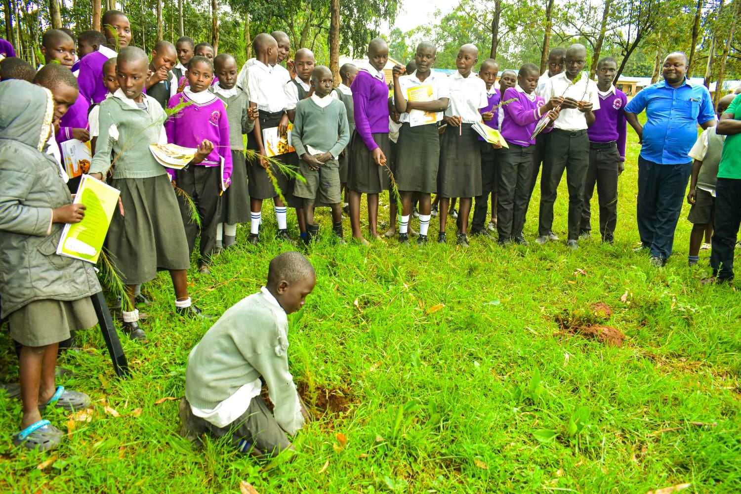 Students watching tree planting demonstration in Migori County, Kenya