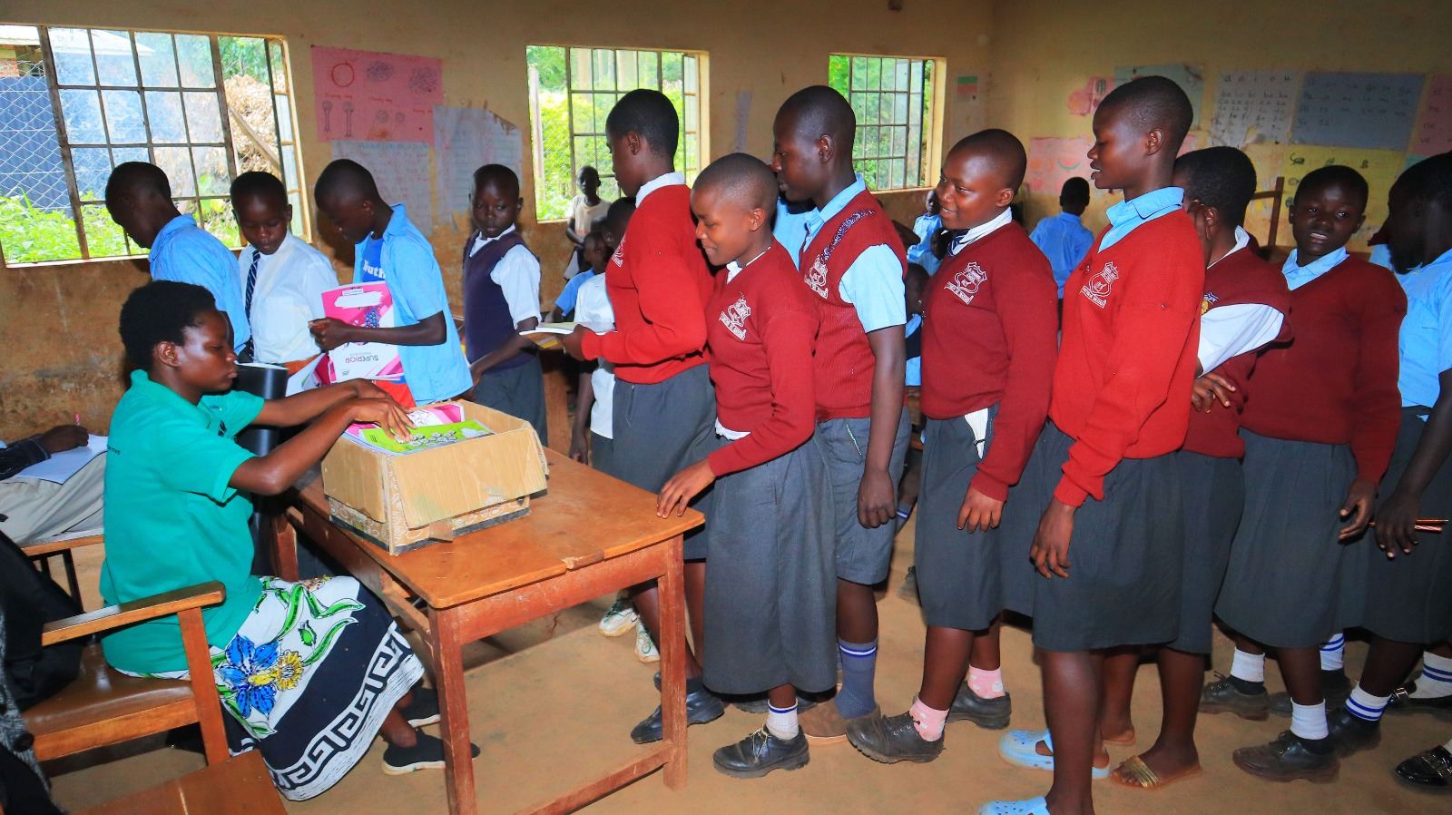 Student receiving supplies at desk during foundation program