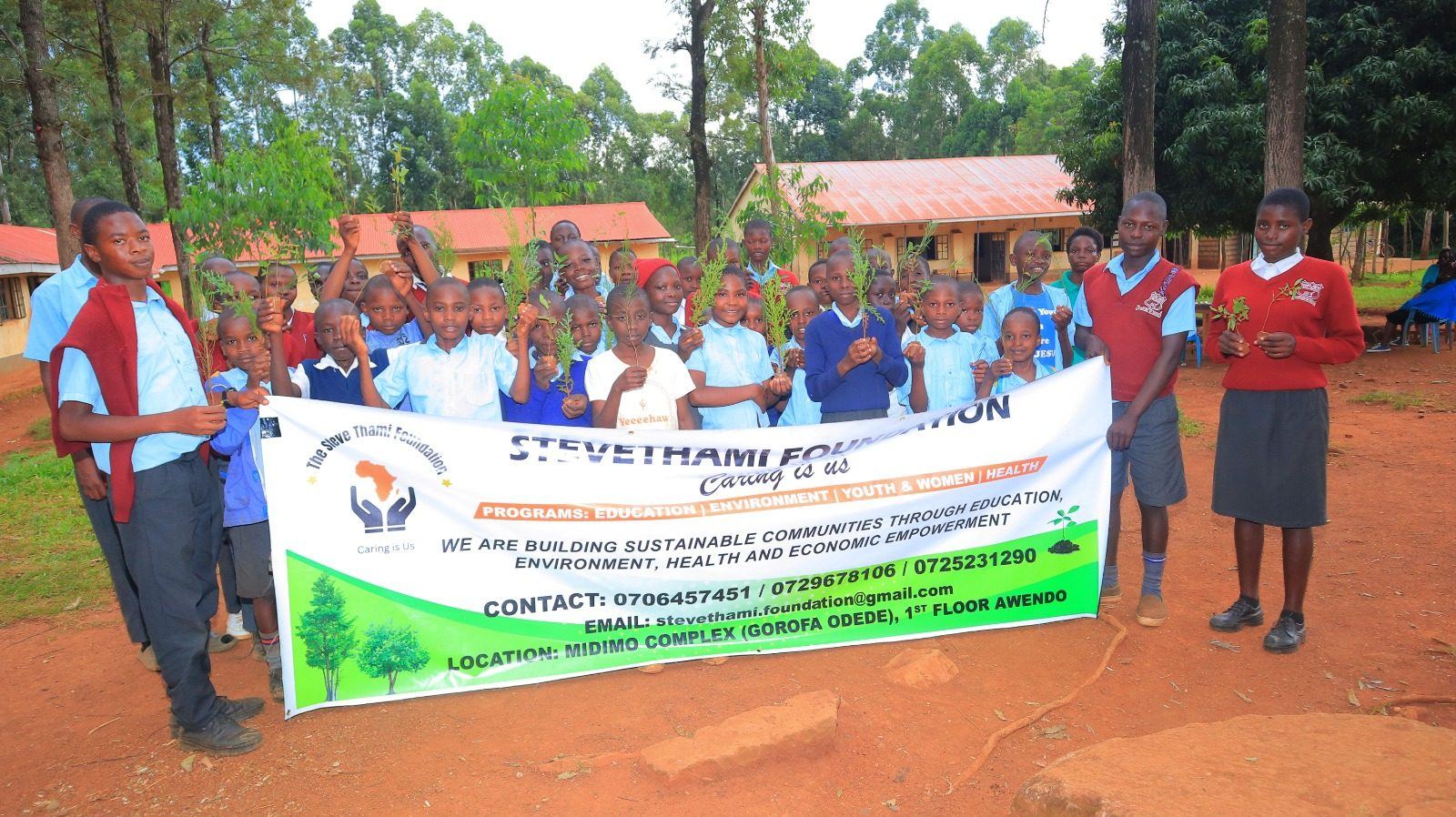 Boy planting young tree seedling in Migori County reforestation