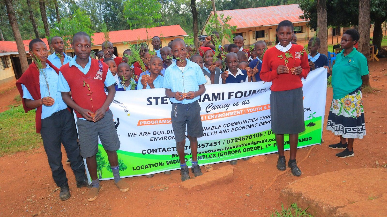Student planting seedling in Migori County environmental conservation program