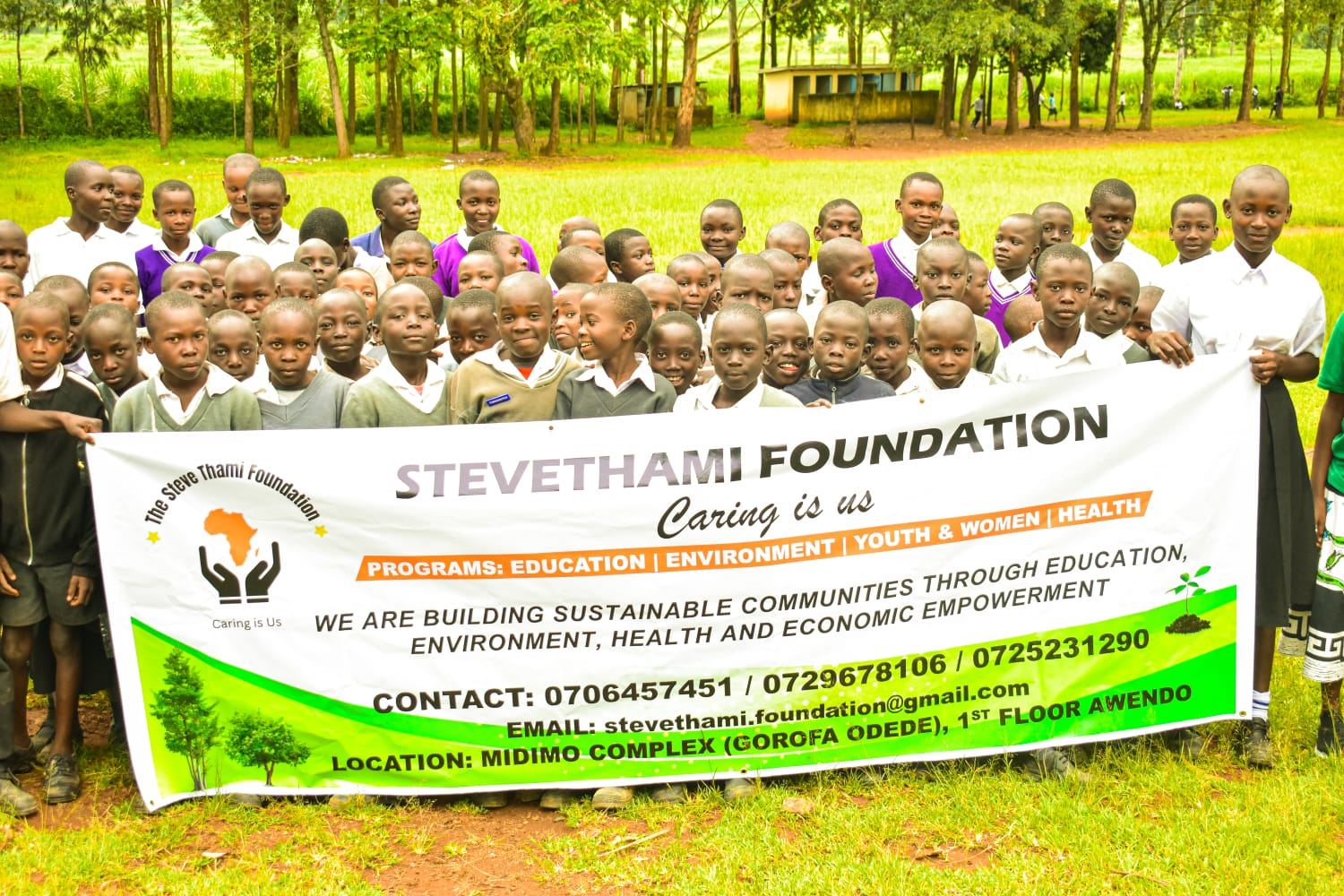 Outdoor group photo with Steve Thami Foundation banner in Migori County, Kenya
