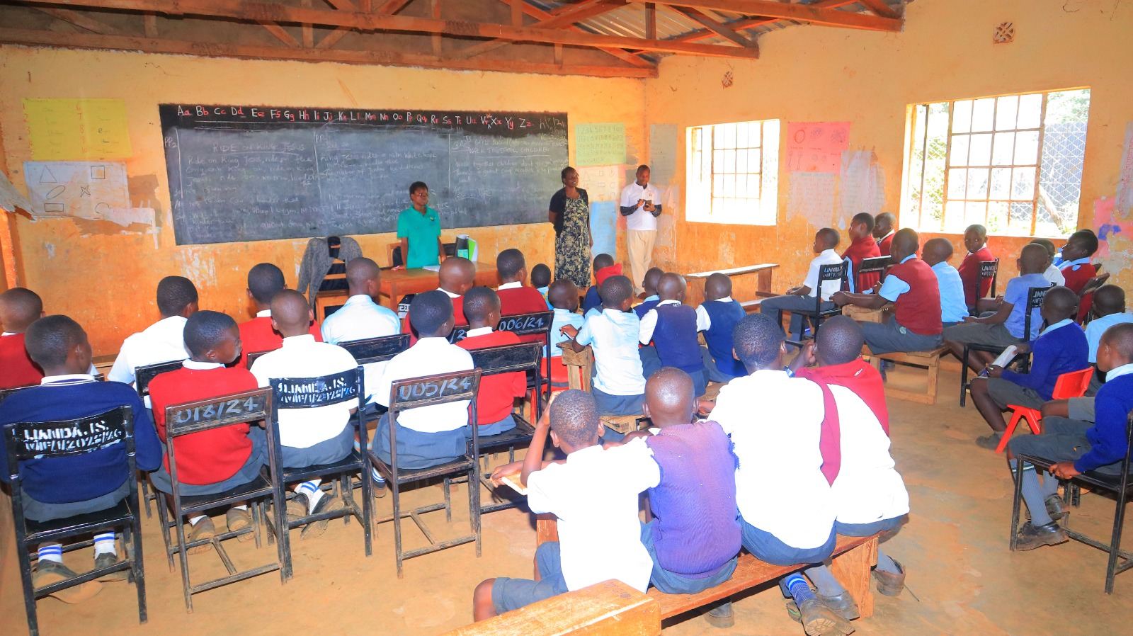 Large school assembly with students seated for foundation program